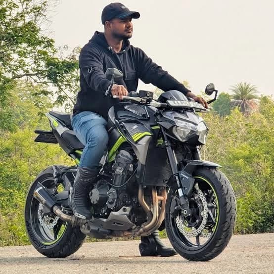 Rider seated on a black and green Kawasaki