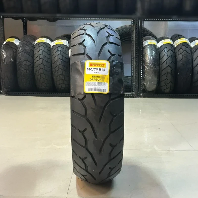 Pirelli Night Dragon motorcycle tyre displayed upright in a tyre showroom